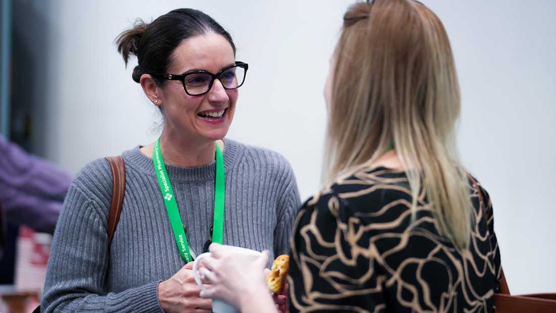 a woman smiling at another woman