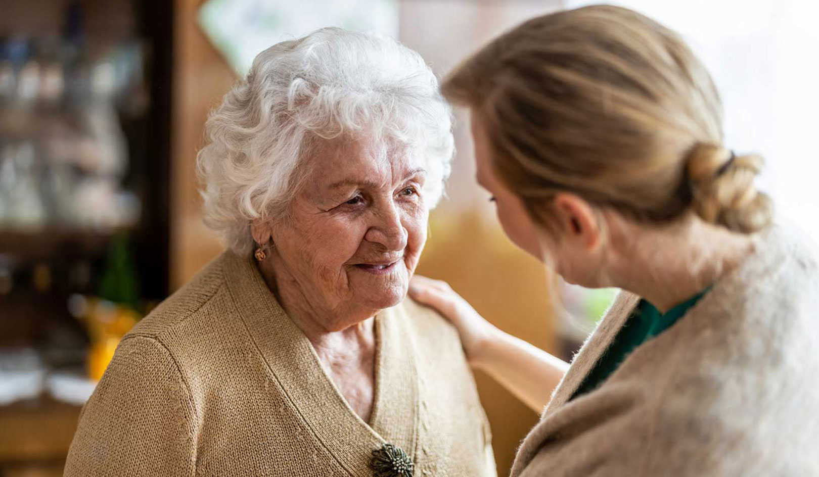 Older person talking with a pharmacy technician