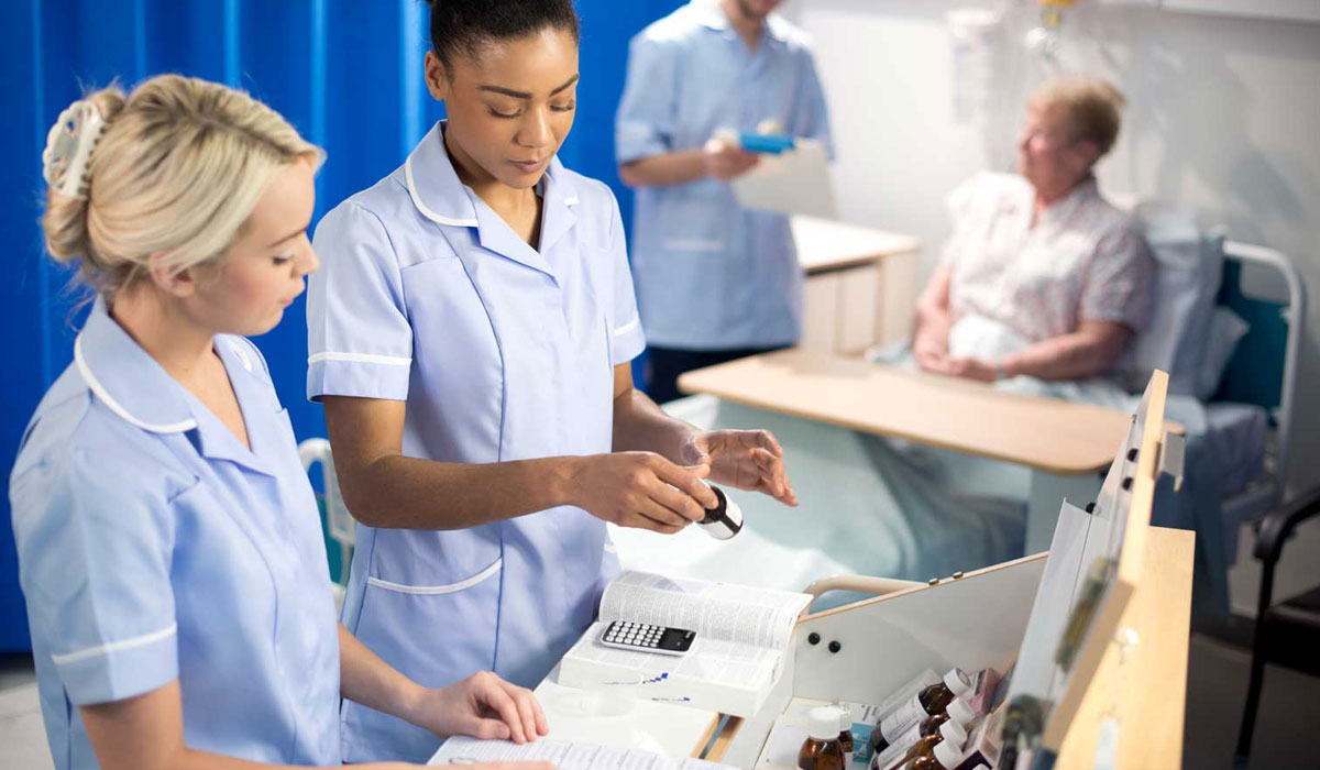 Pharmacists dispensing drugs on a hospital ward
