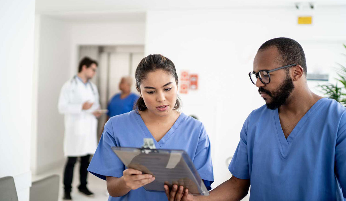 Pharmacists discussing some patient notes